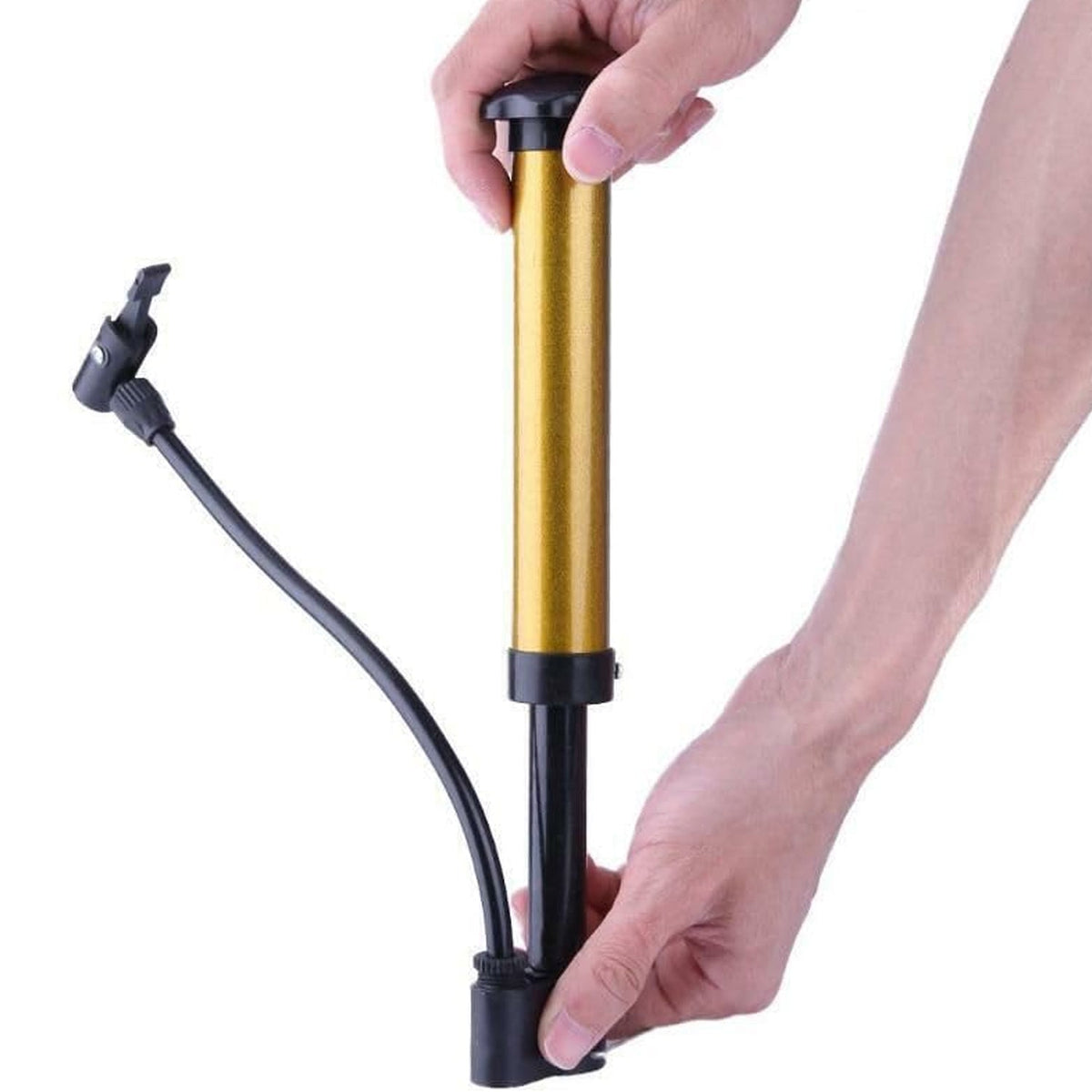 Two hands hold a gold and black hand pump, demonstrating its operation against a white background.