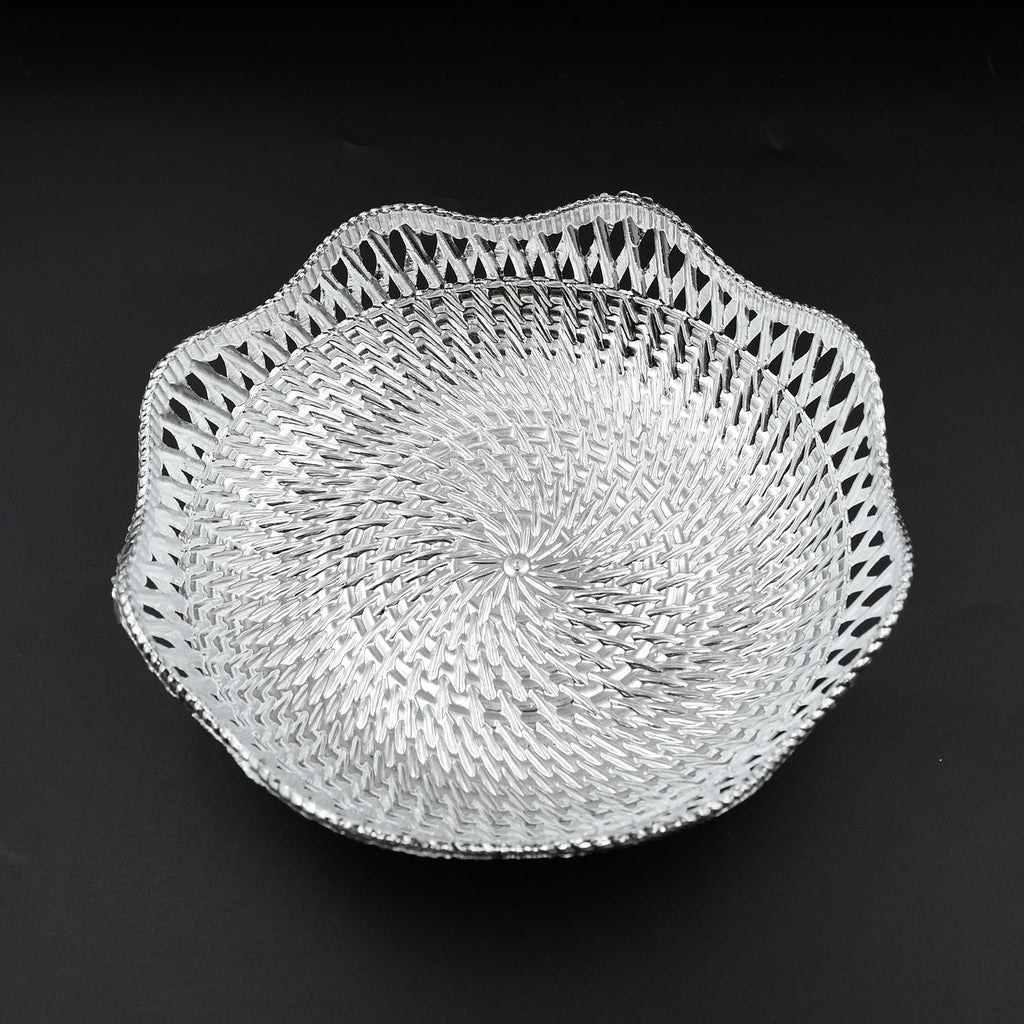 A silver plastic scalloped serving bowl with a textured bottom is centered on a black background.