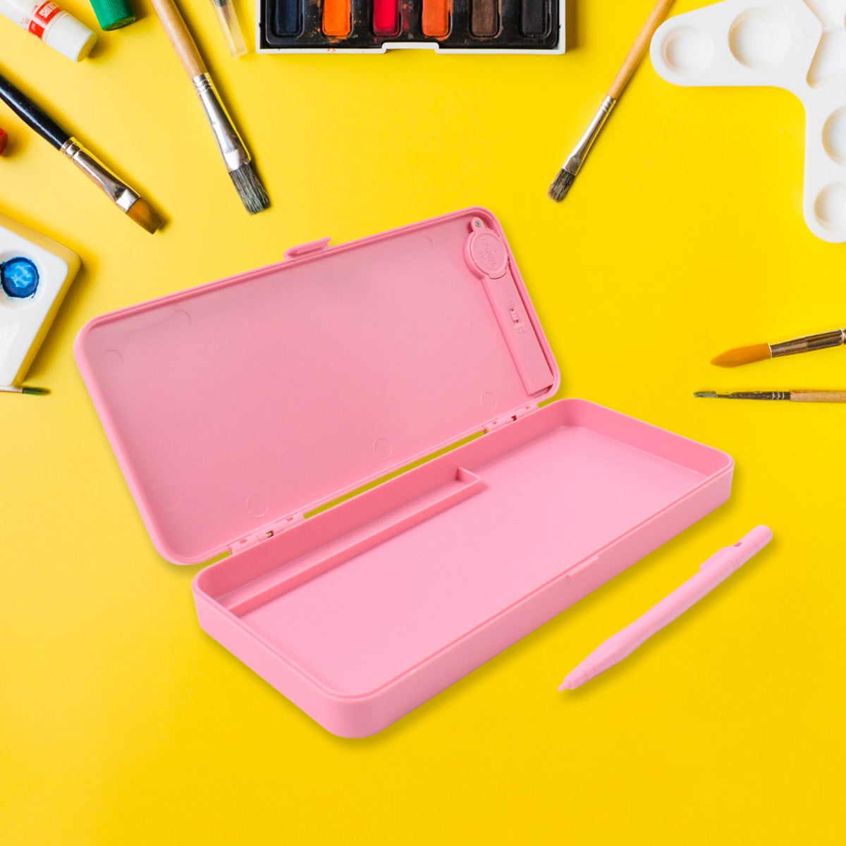 Open pink LCD writing tablet pencil case and a pink stylus on a bright yellow background with art supplies.