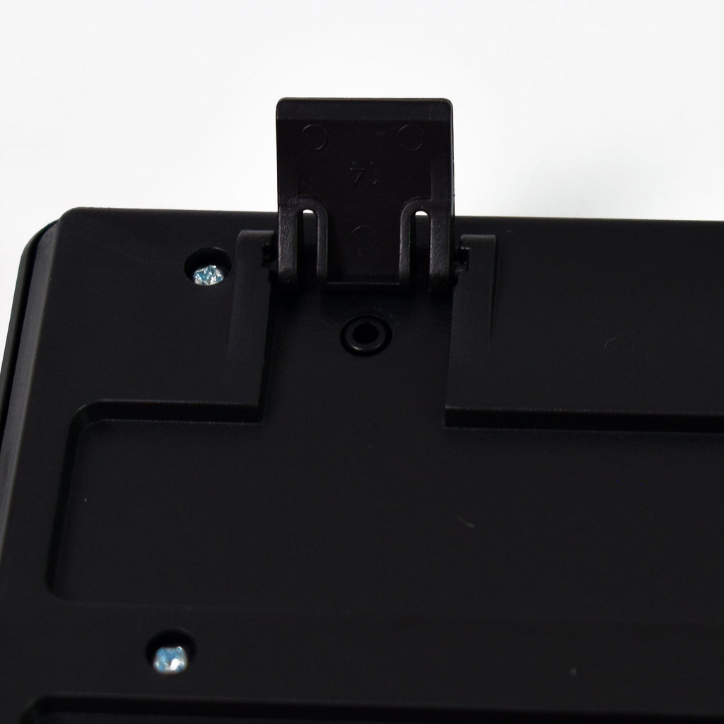 A close-up of the back of a black keyboard showing an extended kickstand and screws.