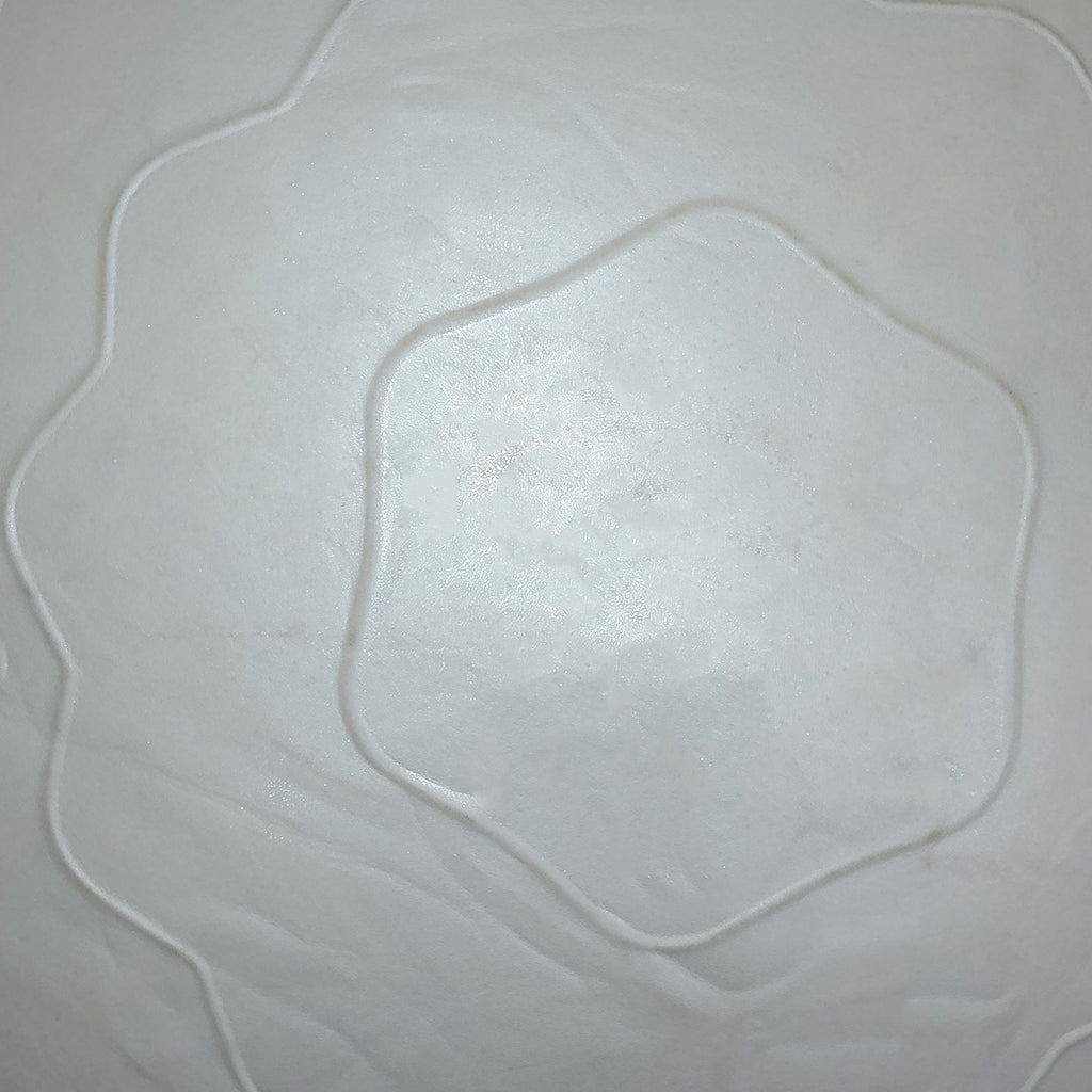 A very close-up, abstract view of the grey stability ball's wavy textured surface, showing a hexagonal pattern.