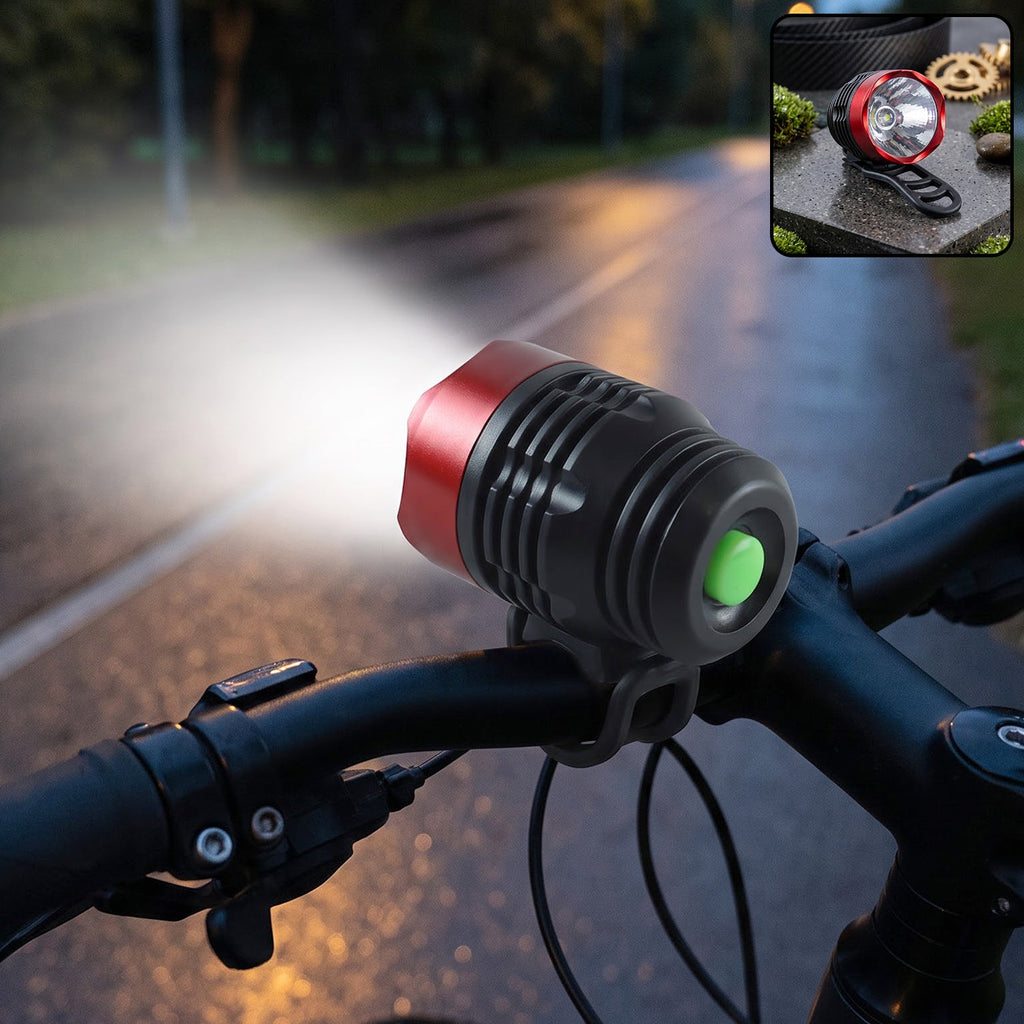 A red and black bicycle headlight with a green button illuminates a dark road from a bike's handlebars.