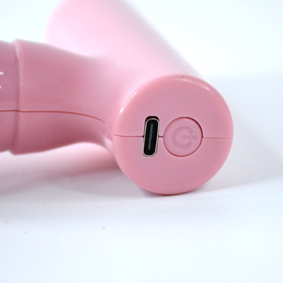 Close-up of the black mini massager's vibrating head, designed for effective muscle relief.