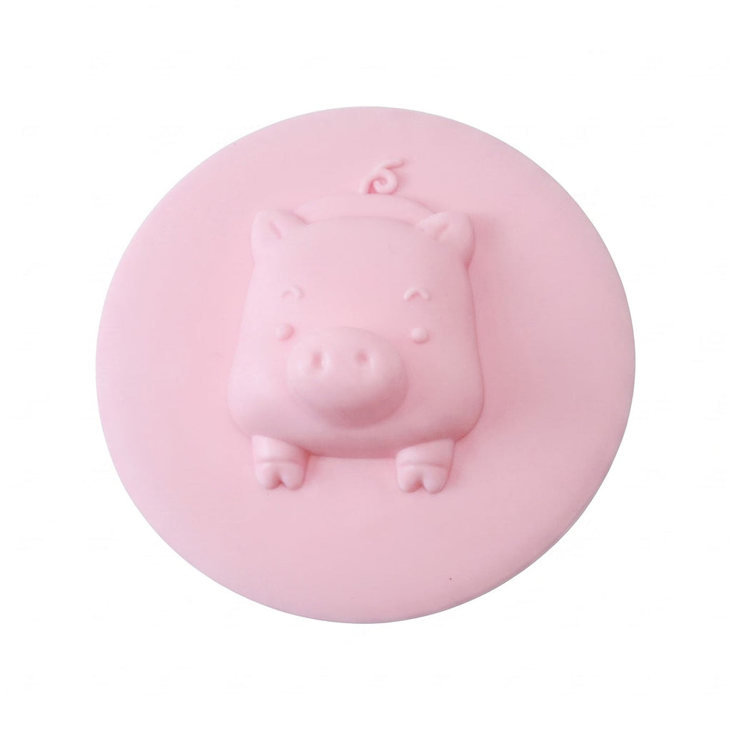 Silicone drain cover with pig design presented on a clean white background.