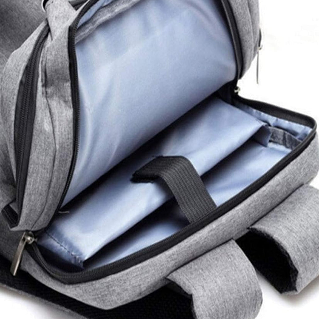 A close-up of the open main compartment of a grey backpack showing padded sleeves and light blue lining.