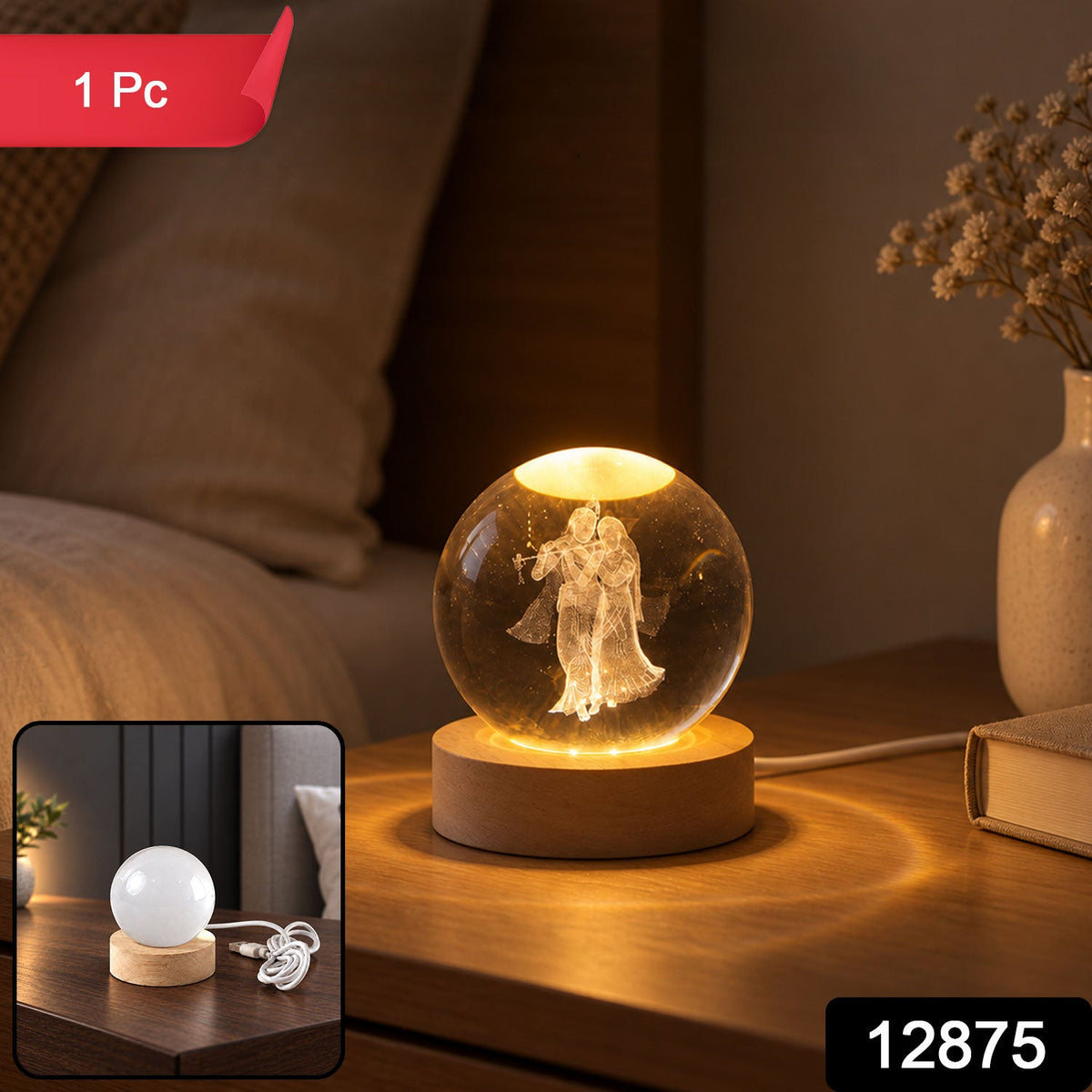 A glowing crystal ball with 3D Radha Krishna engraving on a wooden base, with a red "1 Pc" label.