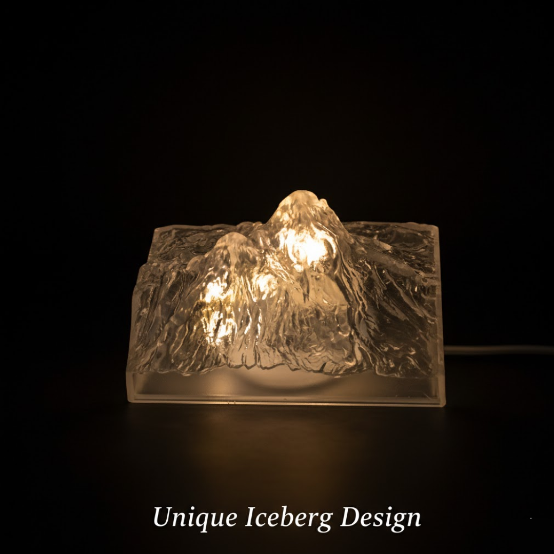 A clear, textured iceberg-shaped LED light glows warmly in a dark setting, highlighting its unique design.