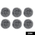 Heavy-duty stainless steel scrubber tackling tough grease on utensils.