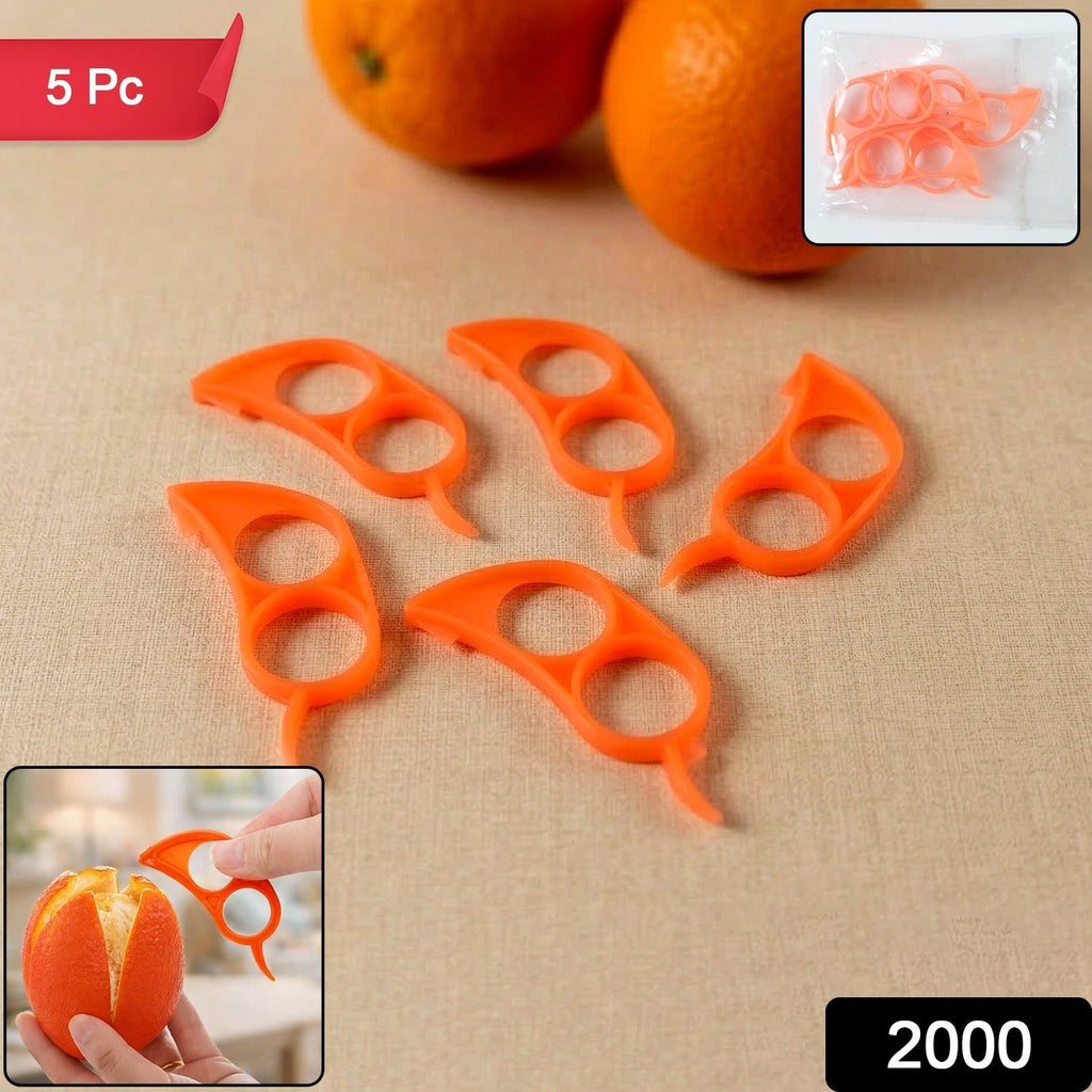 Five orange plastic citrus peelers are displayed on a light brown surface, with two oranges in the background.