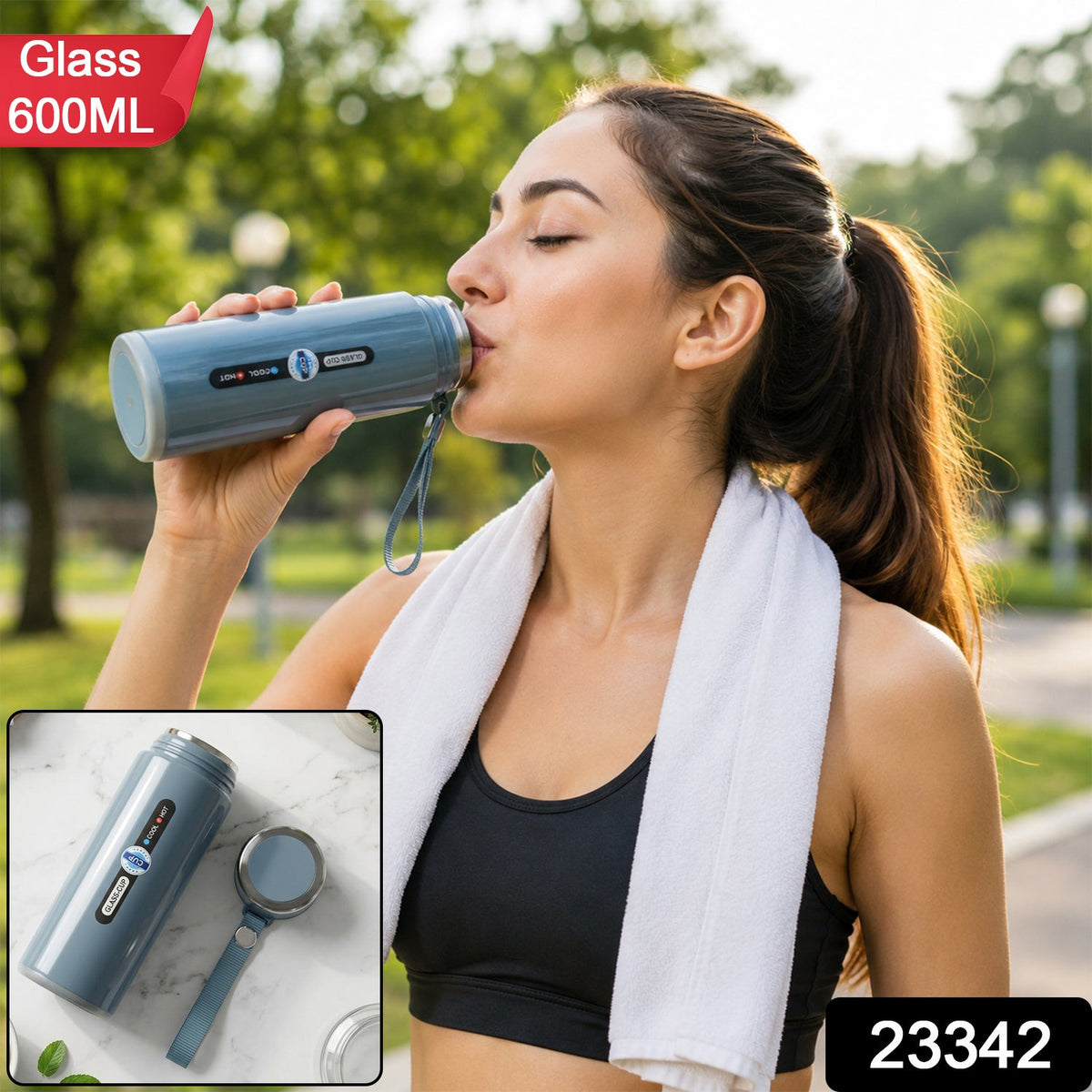 A woman in athletic wear drinks from a blue insulated bottle with a white towel around her neck outdoors. – view 2