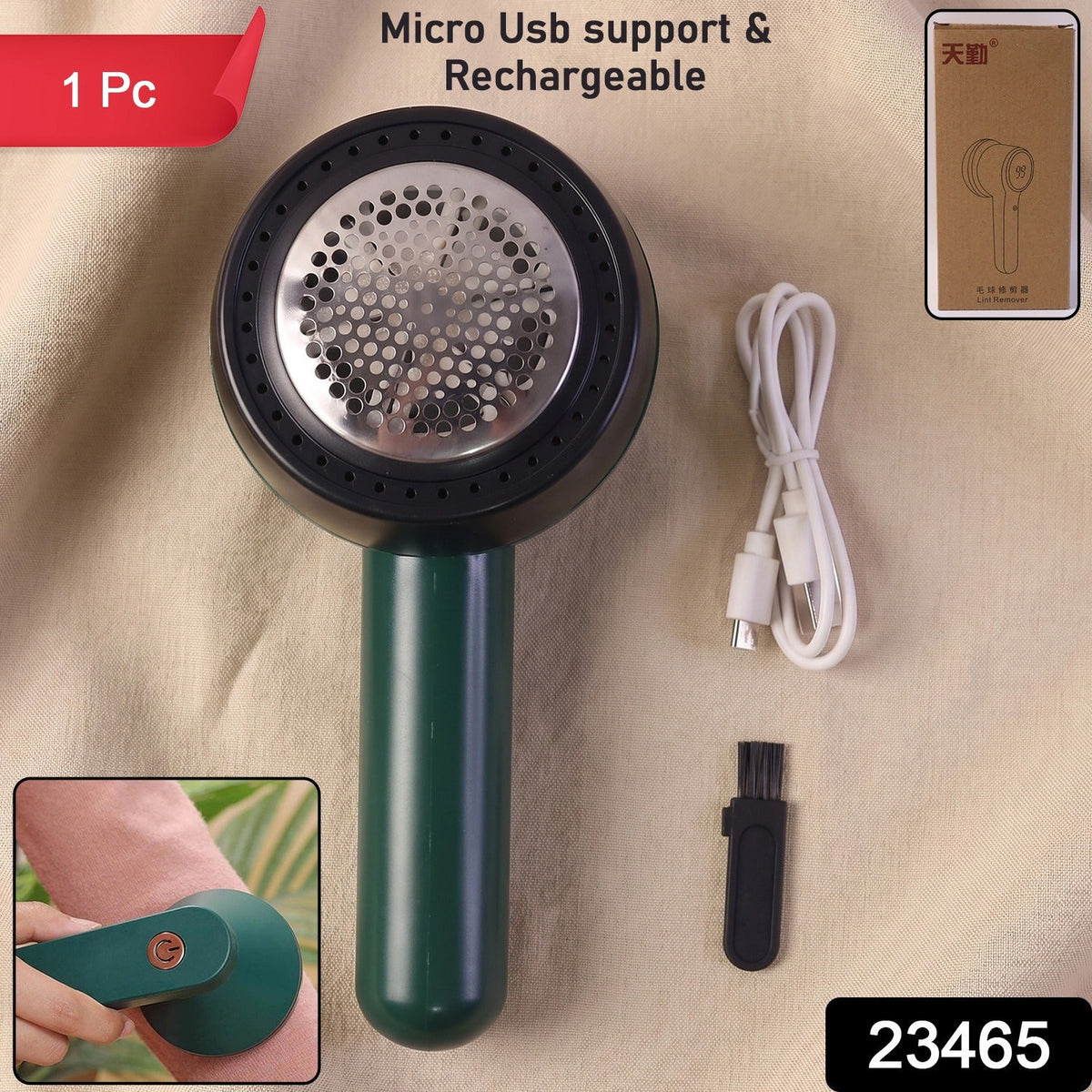 A dark green and black lint remover, white USB-C charging cable, and small black cleaning brush are displayed on  beige