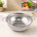 Stainless steel strainer bowl with small holes and two handles on a kitchen counter, with an inset showing it in use.