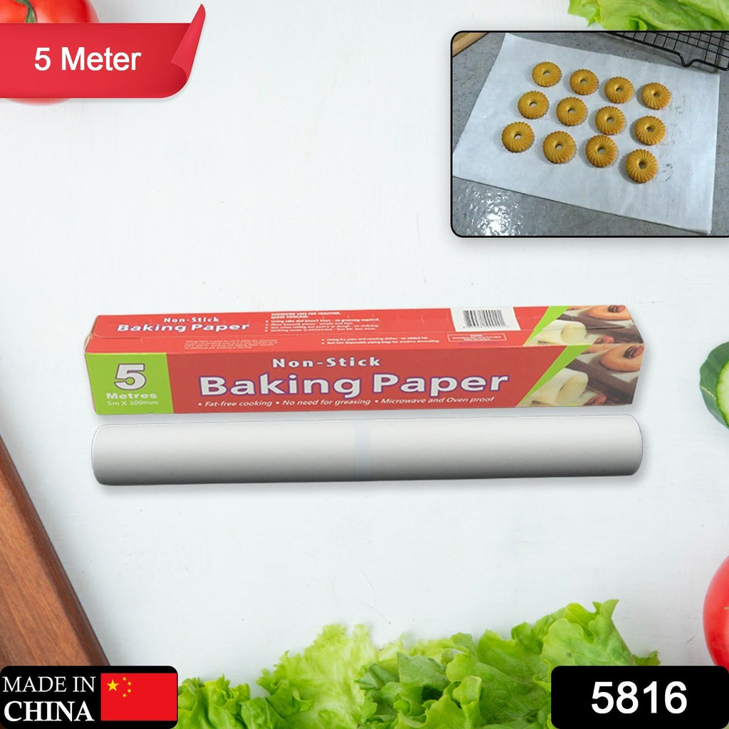 A red and green box of non-stick baking paper and a roll of the paper on a white surface with vegetables and an inset of