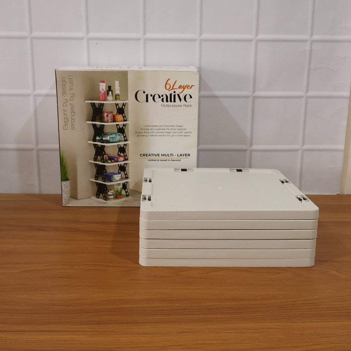 The collapsed light grey shoe rack panels next to its product box, featuring an image of the assembled rack.