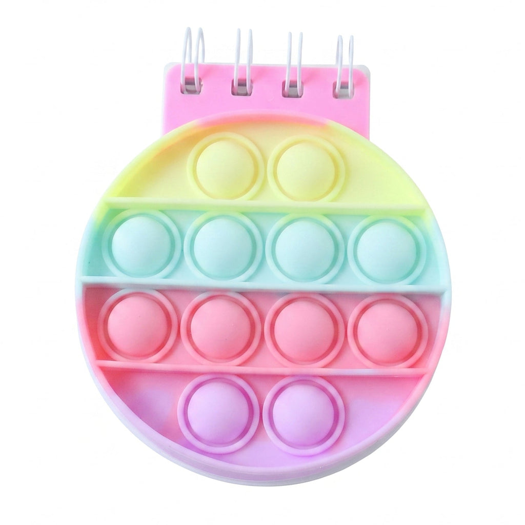 A rainbow pop-it fidget notebook with a pink spiral binding and pastel colored bubbles on a white background.