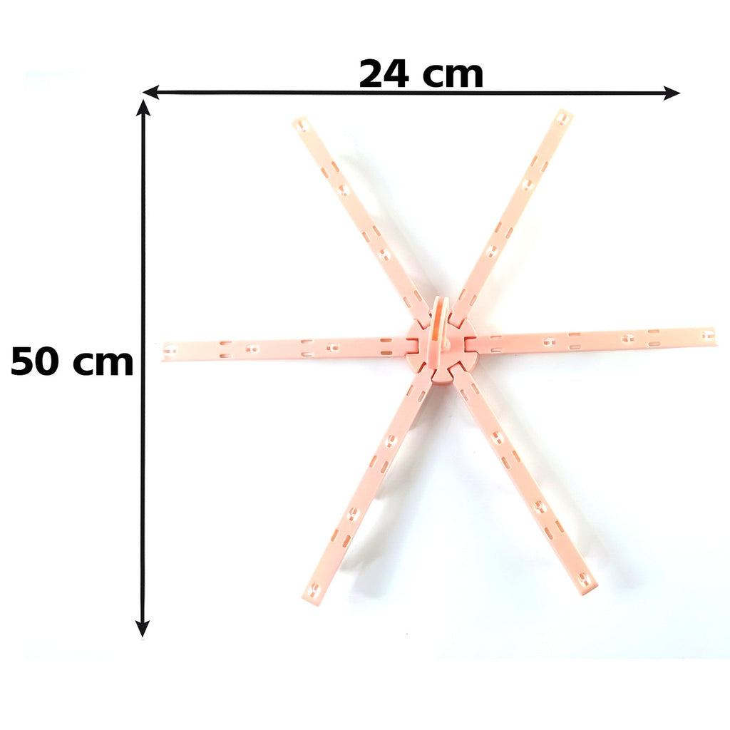 A pink plastic foldable clothes drying rack, unfolded, is shown with dimensions of 24 cm and 50 cm on a white background.