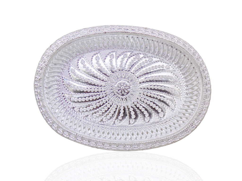 A silver oval decorative serving tray with an intricate floral pattern, viewed from directly above.