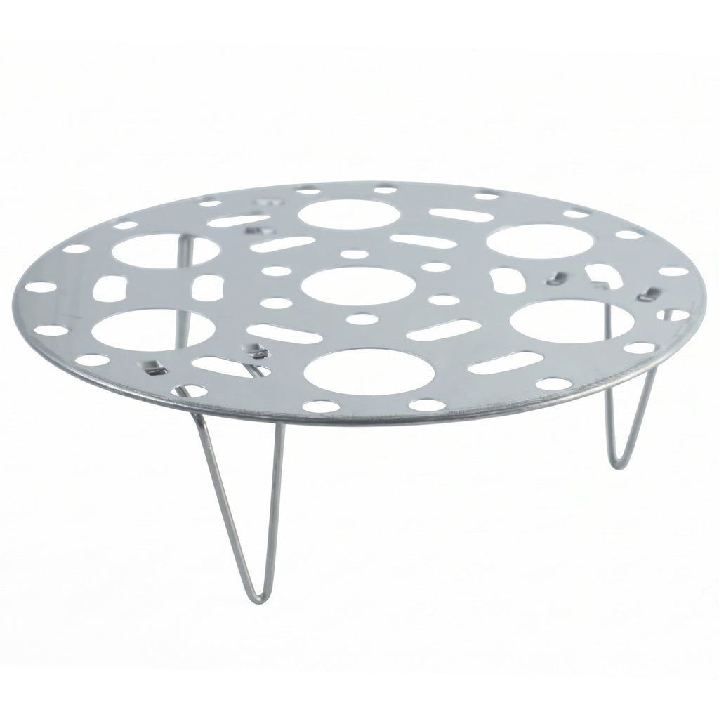 A round, perforated stainless steel steamer rack with three wire legs is displayed against a clean white background.