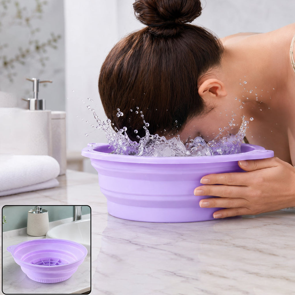 A woman splashes her face in a purple collapsible silicone bowl filled with water and ice cubes on a marble counter.