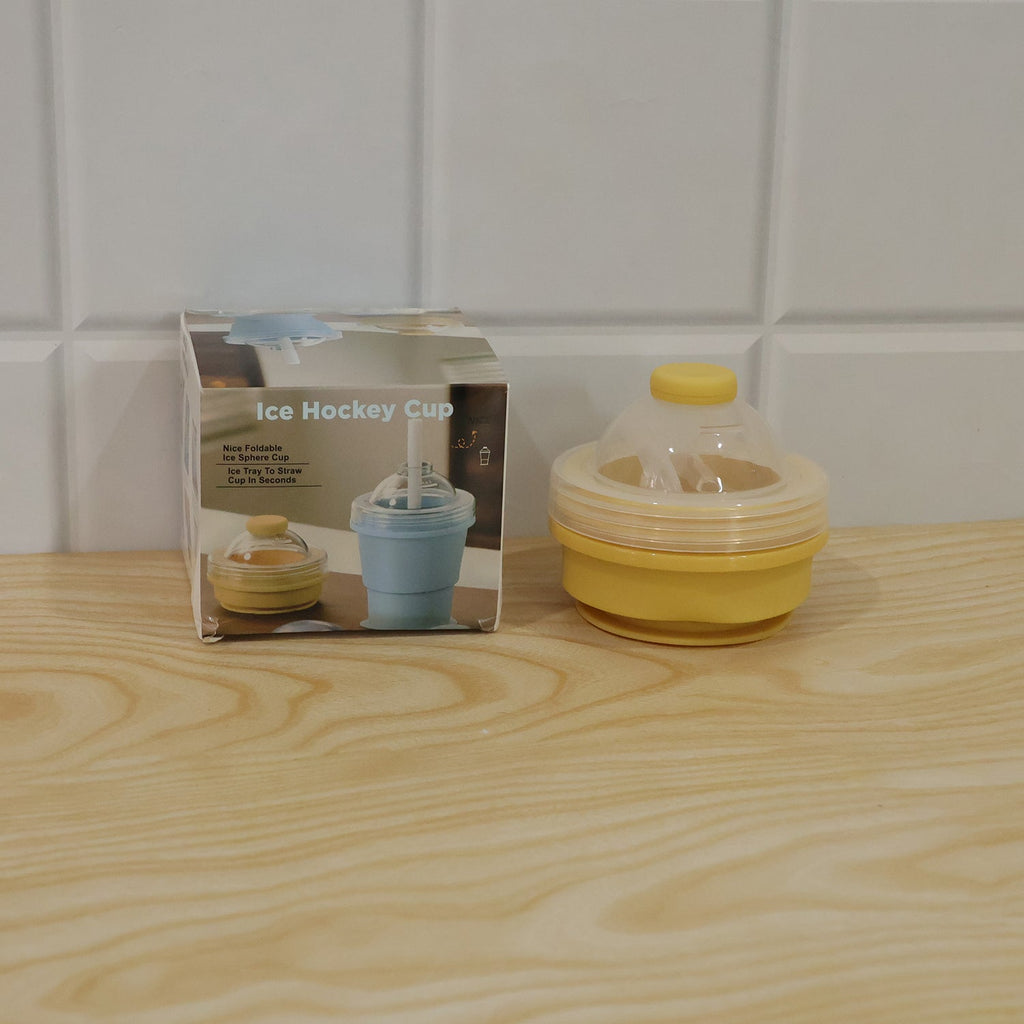 Live photo of a silicone foldable travel cup with straw and dome lid