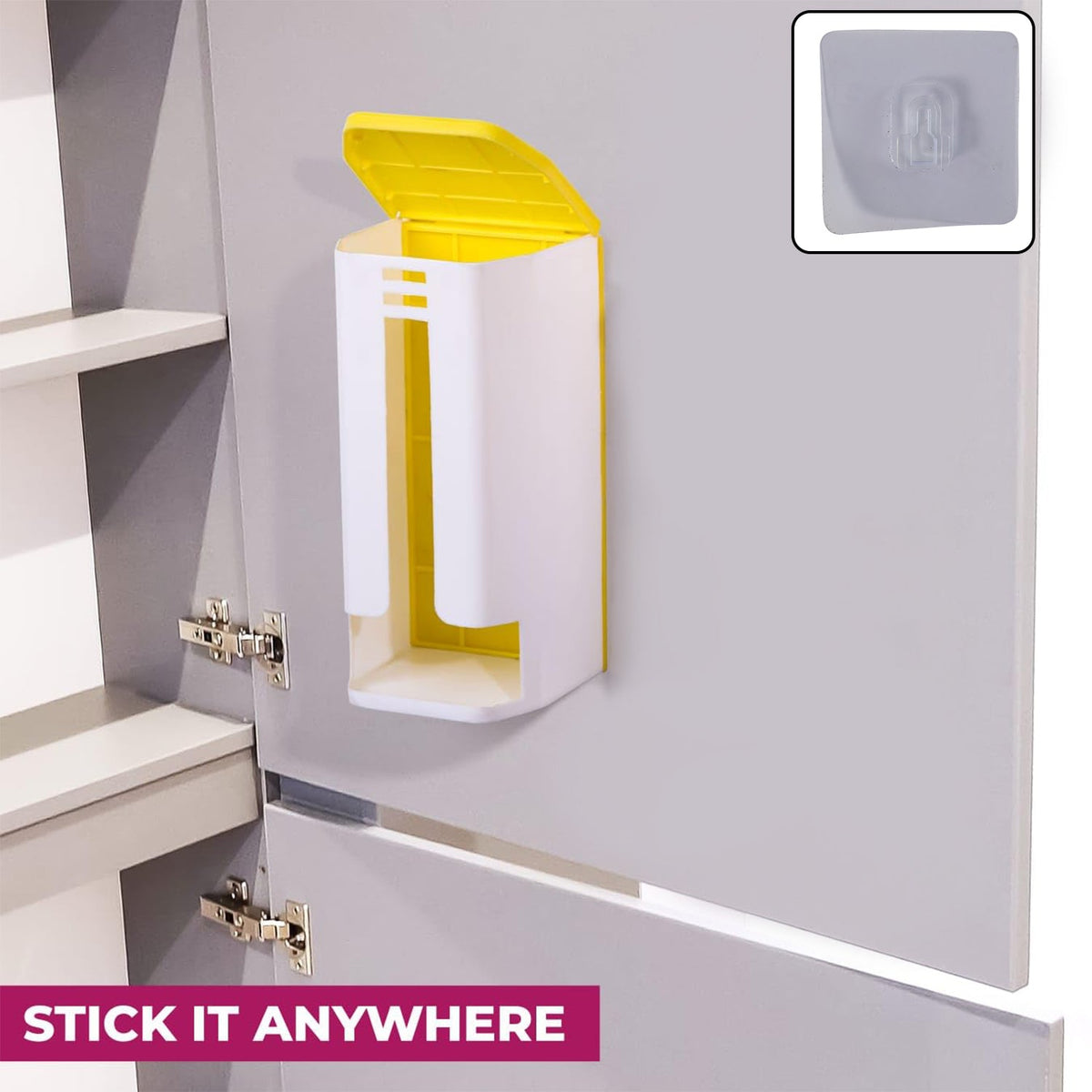 A white and yellow plastic bag dispenser is mounted inside a gray cabinet door, with a clear adhesive hook shown.