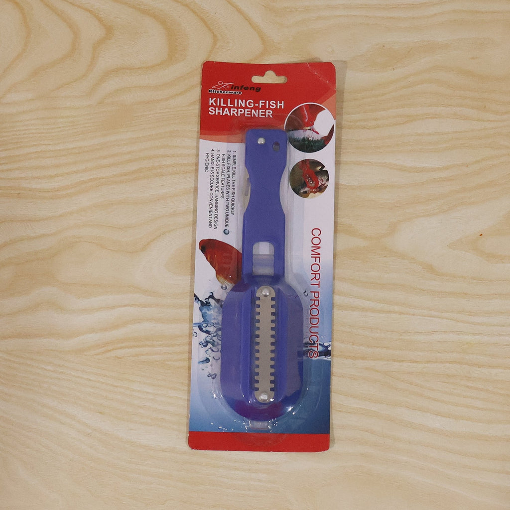 A person holds a blue fish scaler with a clear lid, actively scaling a fish on a wooden cutting board.