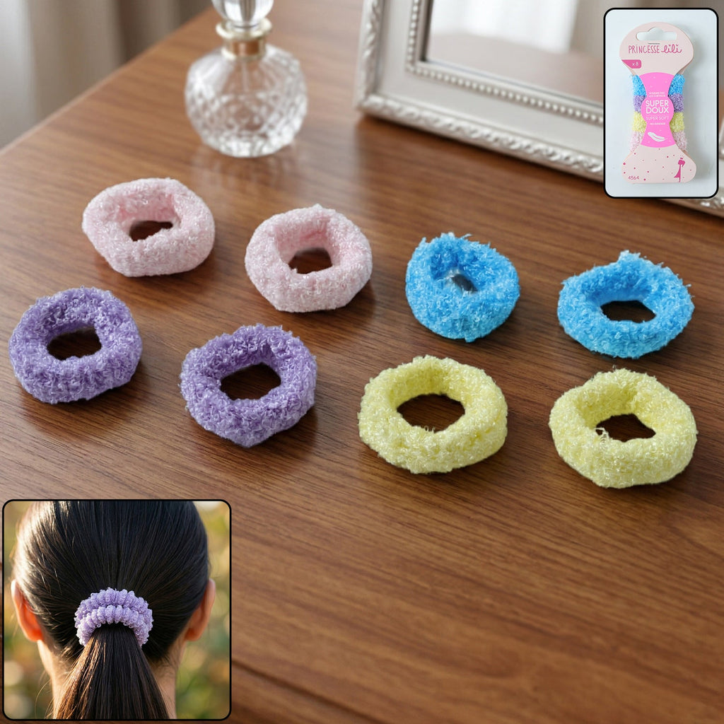 Eight fluffy elastic hair bands in various colors are arranged on a wooden table, with a packaged set in the corner.