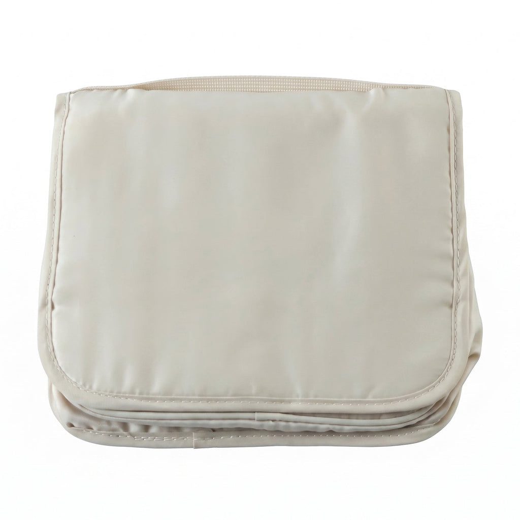 A neatly folded rectangular beige toiletry bag with a handle on a plain white background.