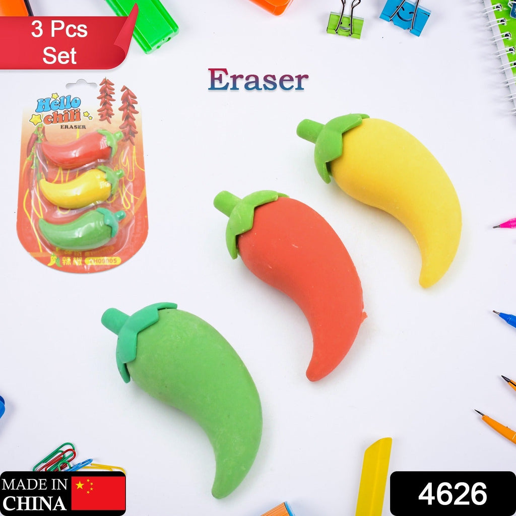 Three chili pepper erasers in red, yellow, and green, with the product packaging and other school supplies scattered around.