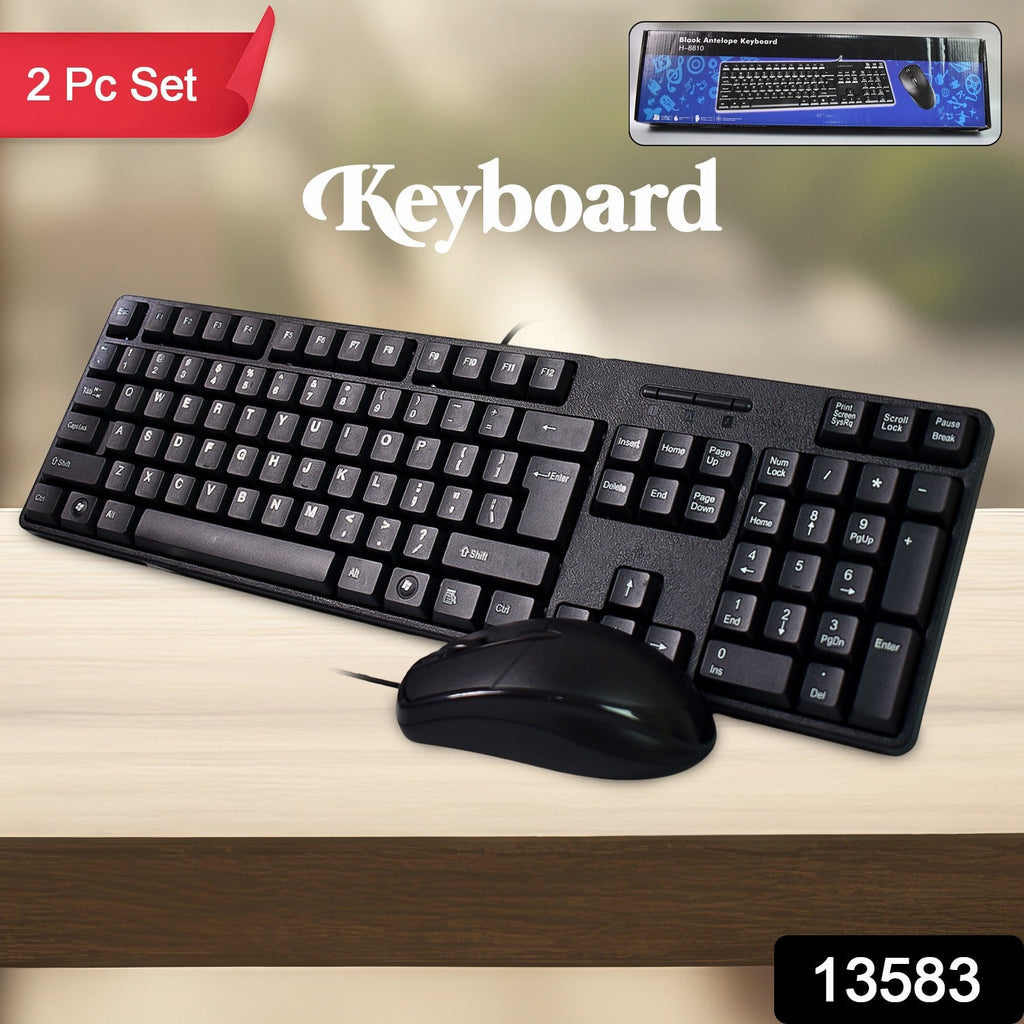A black wired keyboard and mouse combo on a wooden surface, with a product box in the top right corner.