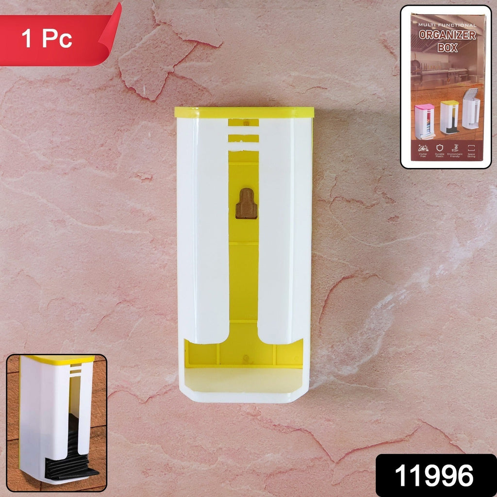 A white and yellow plastic bag dispenser is mounted on a pinkish-brown textured wall.