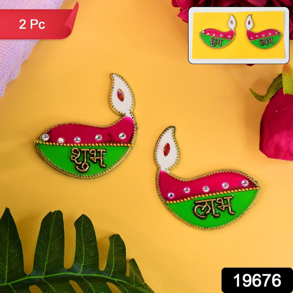 Two diya-shaped stickers, pink and green with gold text, on a yellow background with a small inset image of the same.