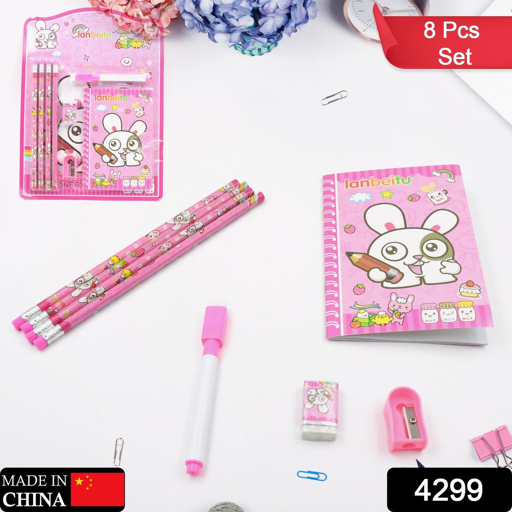 The pink bunny stationery set is laid out on a white surface with small office clips and a floral background.